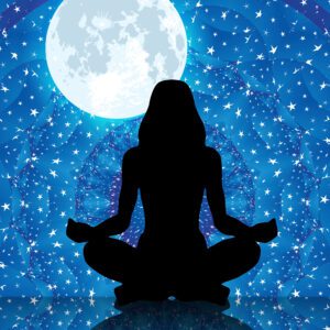 Woman’s silhouette meditating under the moon with mandala background